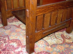 Close-up side slats and pinned through-tenons on leg and wide shelf through- tenon which passes through the arched side stretcher.